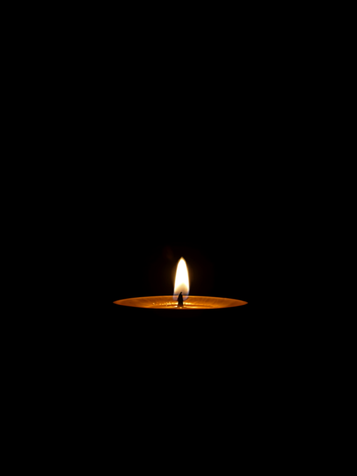 A single oil lamp burning steadily in soft warm light, suggesting sustained rather than perfect balance